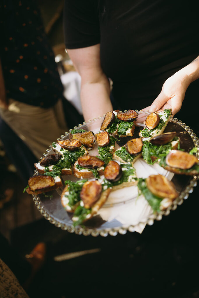 Fresh wedding appetizers being passed on a tray.