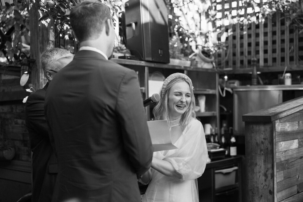 Bride laughing during ceremony.