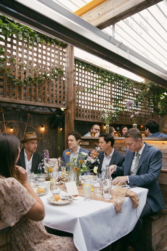 Wedding guests sitting around the table chatting.