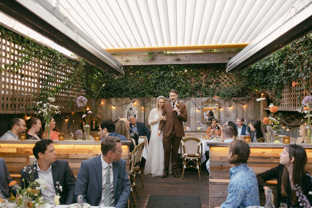 Bride and groom giving thank you speech.