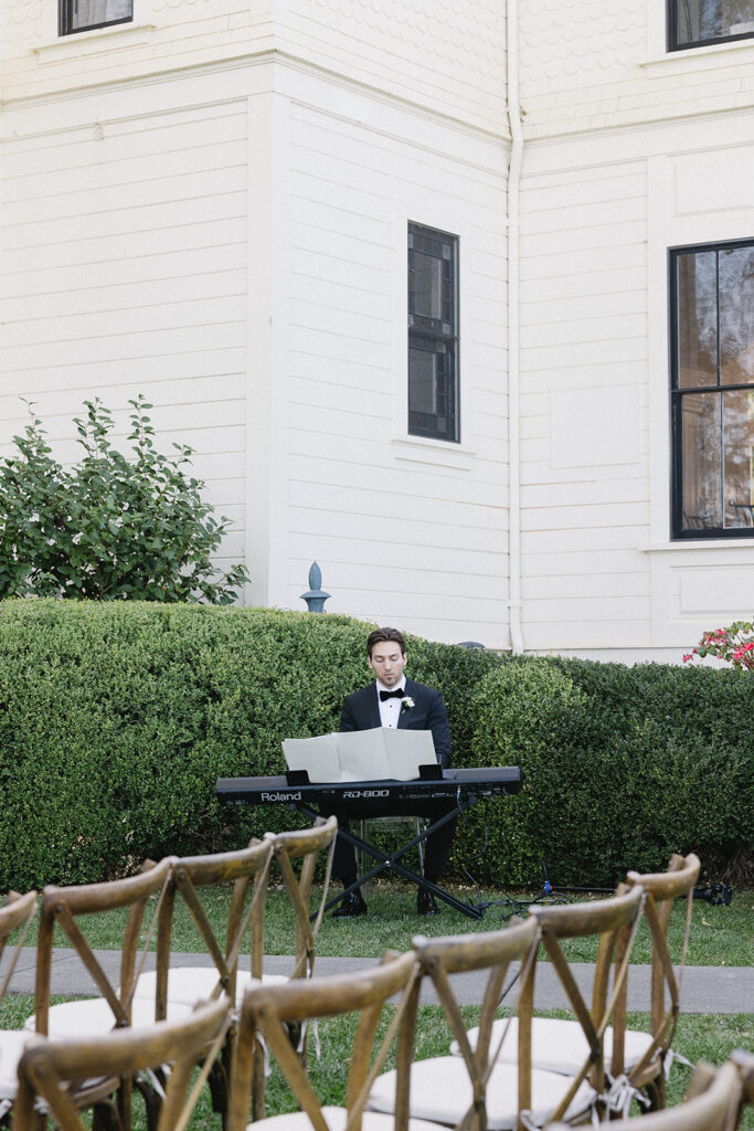 Piano player at outdoor ceremony.