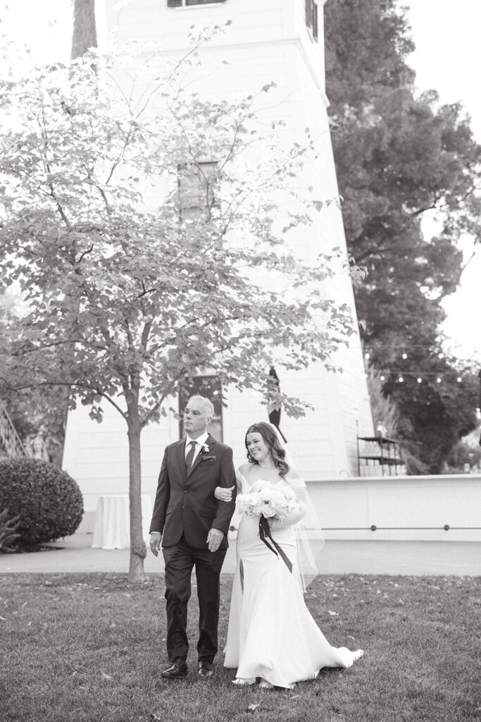 Father of the bride walking the bride down the aisle. 