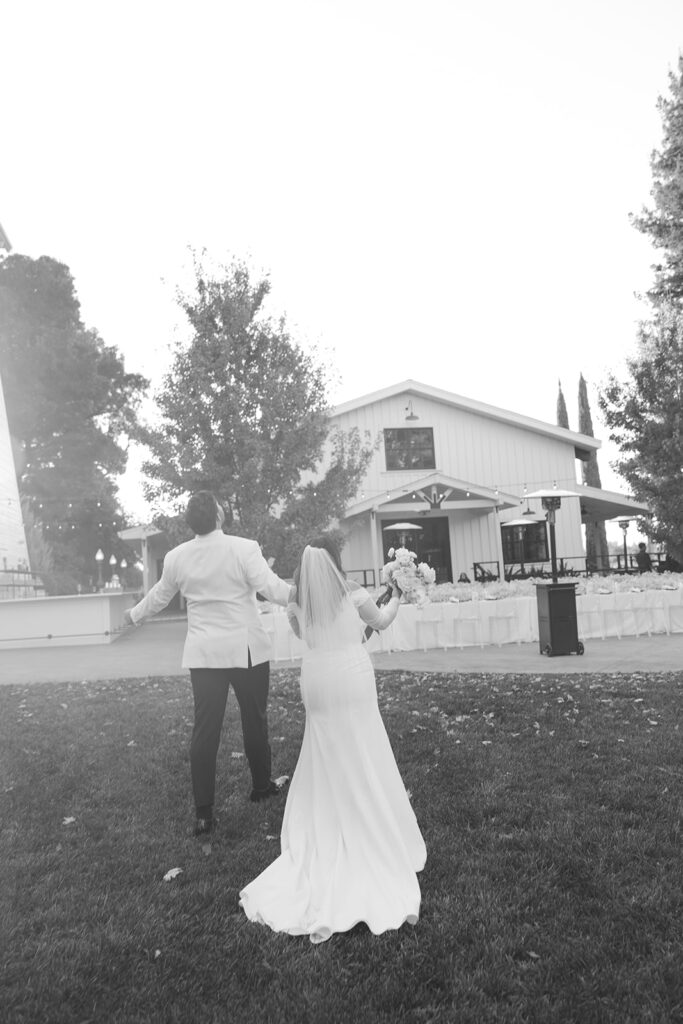 After walking down the aisle couple holding hands taking in the moment together.