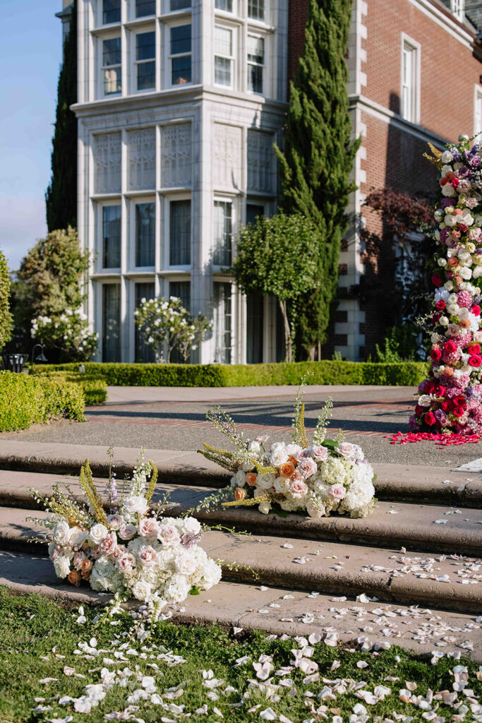 Wedding ceremony floral, petals, and arch.
