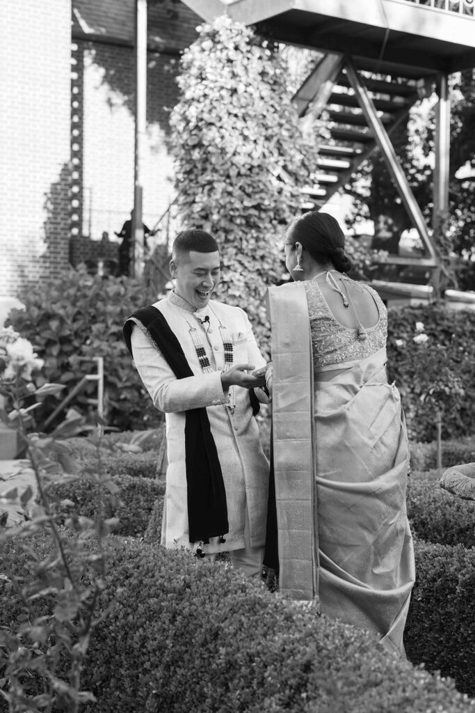 Groom admiring the bridal henna on his brides hands during their first look.