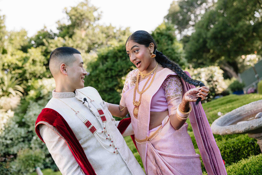 Bride dropping her jaw at her man while he smiles and admires her.