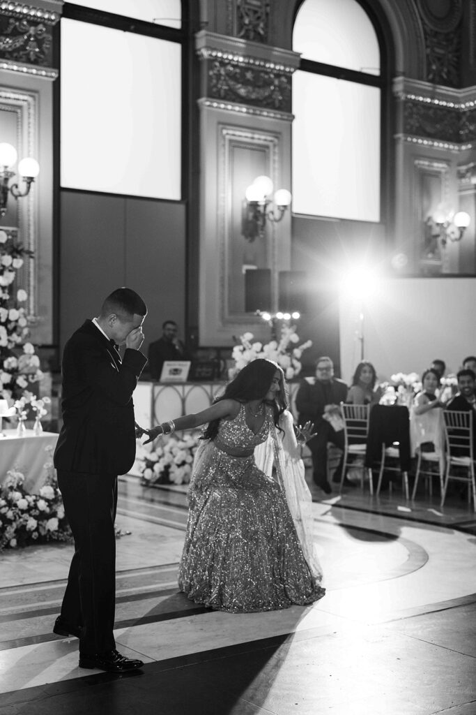 Bride bowing while groom covers his face.
