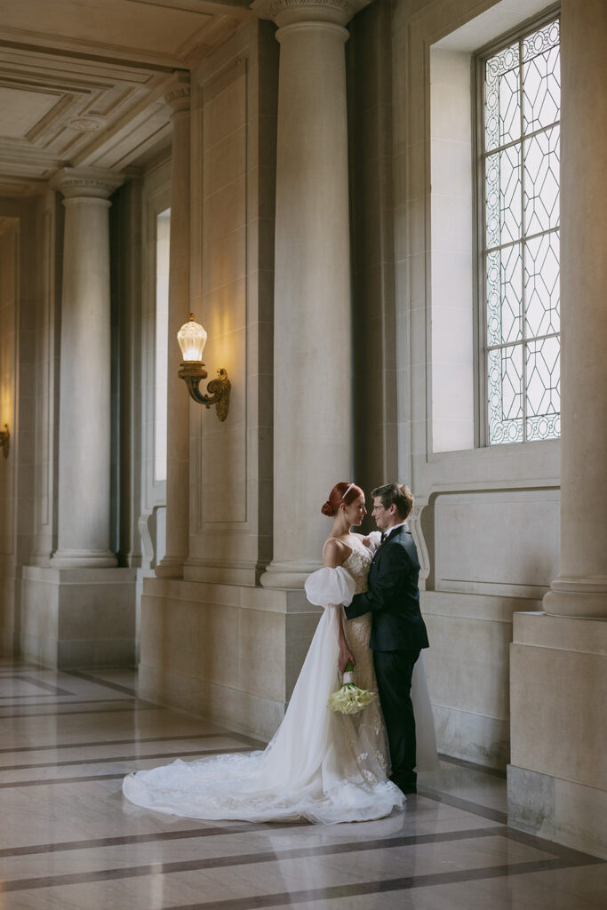 Bride and groom having an intimate moment from far away looking into each others eyes