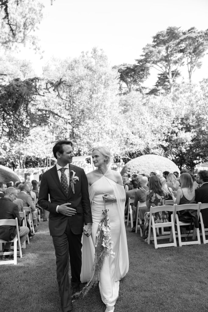 bride and groom walking back down the aisle after saying i do.