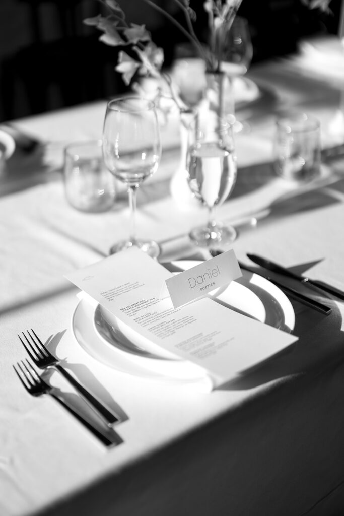 black and white photos of a sunset tablescape with modern wedding menus