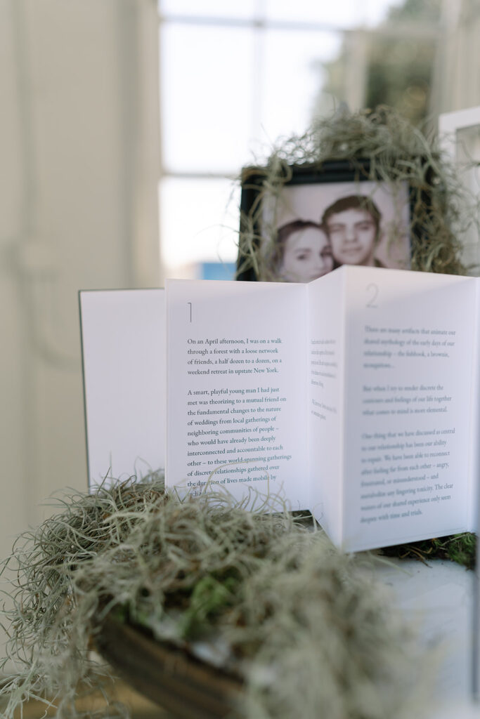 wedding welcome table with the bride and grooms love story like a storybook printed