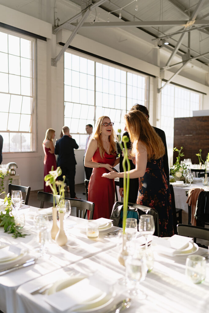 Wedding guests greeting each other as they enter the wedding reception