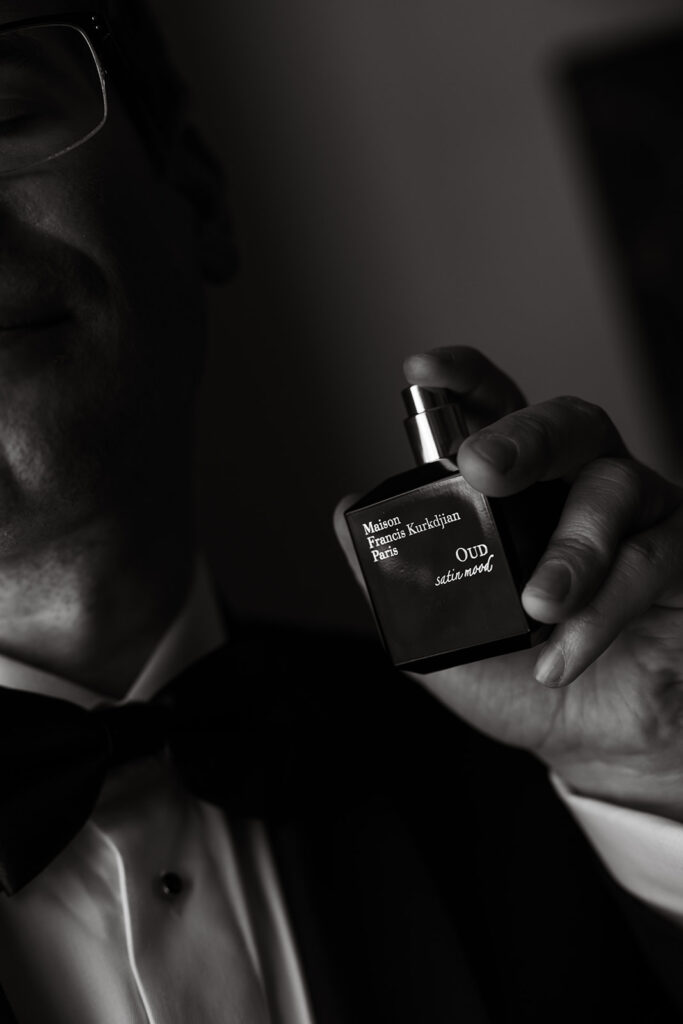 Groom spraying his cologne on himself, "Maison Francis Kurkdijian Paris" in the scent "Oud Satin Mood"