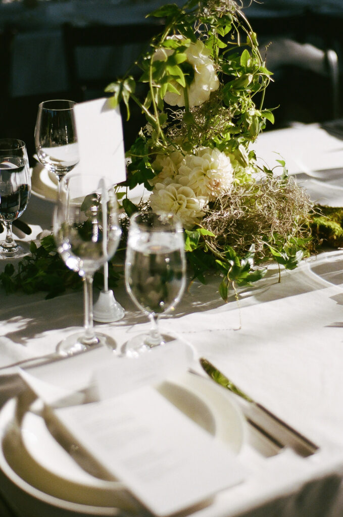 wedding reception tablescape with mossy white florals