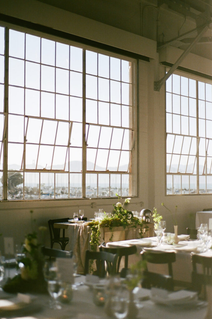 Sweetheart table on film captured from behind the guest tables