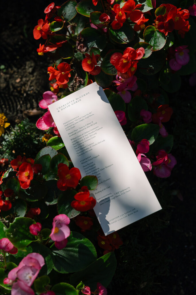 Wedding ceremony paper placed in beautiful red and pink floral bush