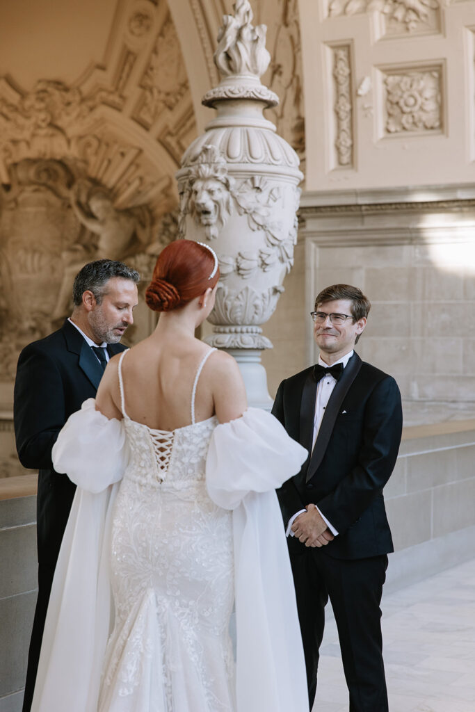 City hall wedding ceremony, groom wearing an all black tux and black bow tie.