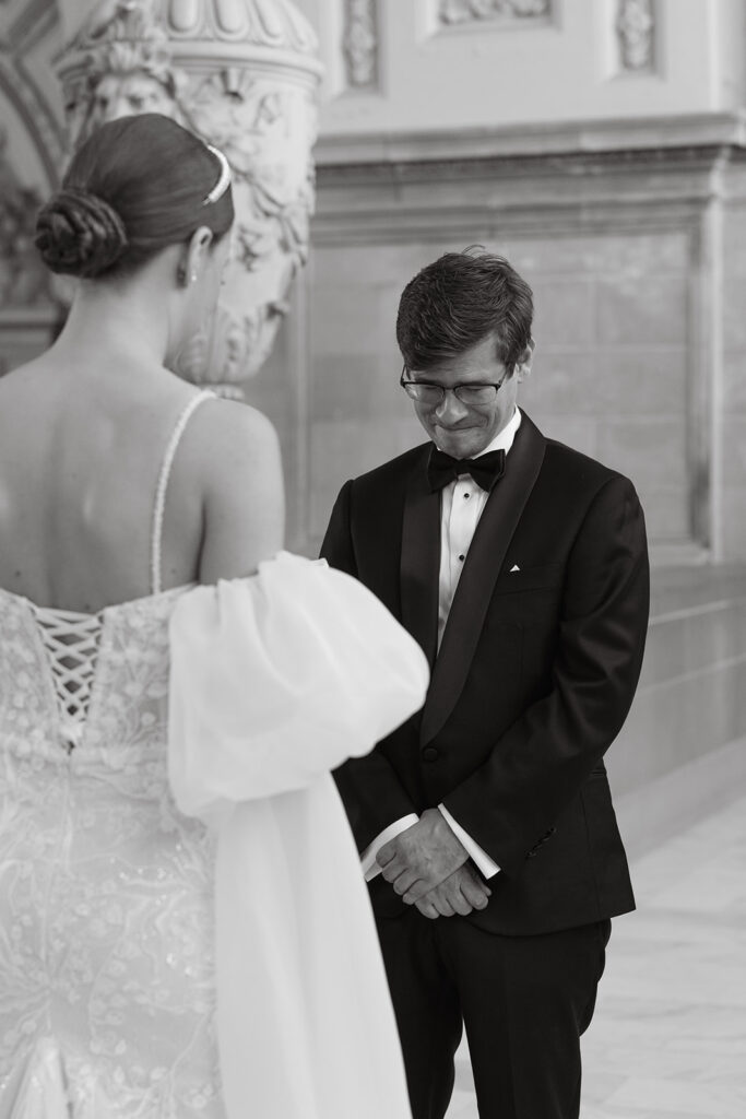 Groom getting choked up during wedding ceremony as bride reads her vows