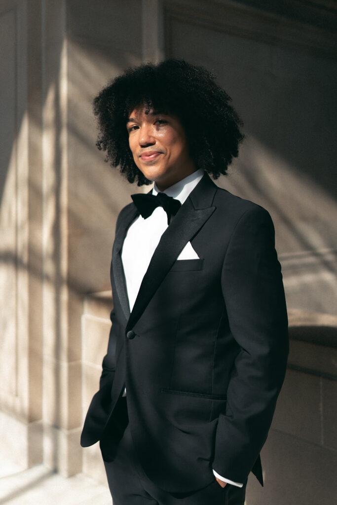 editorial film photo of groom soft smiling into the camera